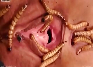 Masked blonde can't hide moans of pleasure from sex with worms