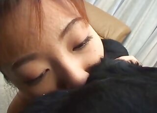 Young Japanese babe is tasting dog's butt for the very first time
