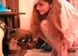 Two sluts take turns to suck hard pecker of a dog at home